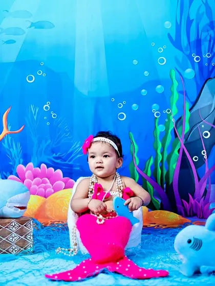 A full setup view of the pink mermaid theme, with the baby sitting in her shell.