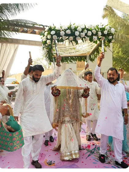 A beautiful moment from a Nikah ceremony, as the bride makes her entrance under a *phoolon ki chadar*. This is a perfect example of how we help create timeless, emotional memories.