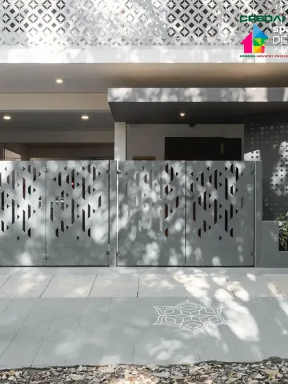 A person walks past the custom-designed gate, highlighting the home's connection to the public realm and its contribution to the street's aesthetic.