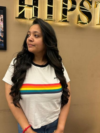 A client embracing her natural curls, styled to perfection for a look of effortless charm and beauty.