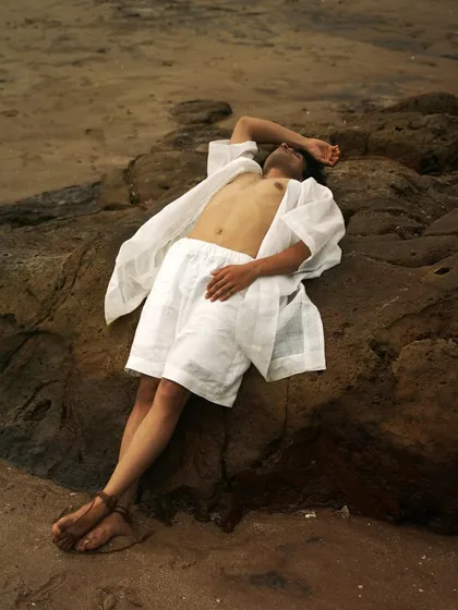 This series showcases a male model interacting with the natural beach environment. From the water to the rocks, each shot captures a different mood, perfect for an editorial story.