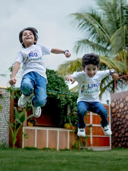 Double the giggles, double the grins. Capturing the pure energy of brothers jumping for joy.