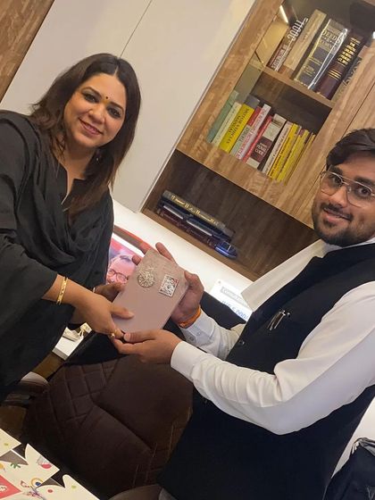 Presenting the advocate's band to another promising young lawyer. It is a proud moment to see the next generation ready to uphold justice.