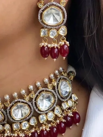 A close-up look at the fine making of our polki and ruby choker necklace. Notice the clarity of the uncut stones and the deep red of the ruby beads, designed to give you a look that is not at all less than real gold.