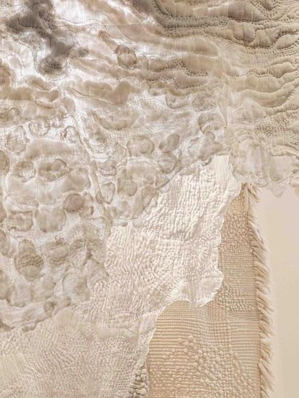 A close-up of the textures in the 'Sleep Sense' installation. The hand-felted wool and soft-stitched fabrics create a landscape that is both visually and tactilely soothing, designed to evoke a sense of calm and rest.