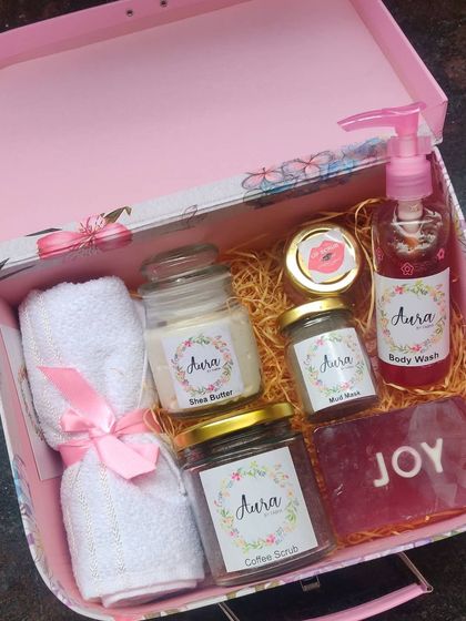 This floral suitcase box is filled with a custom selection of my products. It includes a personalized 'JOY' soap, coffee scrub, shea butter, body wash, mud mask, and towels.