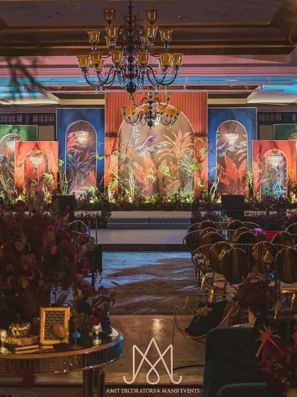 The complete stage setup, showcasing the interplay of colorful backdrops, neon-lit arches, and lush florals. This design is perfect for clients who want a bold, non-traditional sangeet.