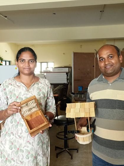 Kanthi proudly displays the Kumiko box she created, featuring the Asa-no-ha pattern on the lid. Beside her, Rajashekhar holds a wishing well he built in the same workshop.