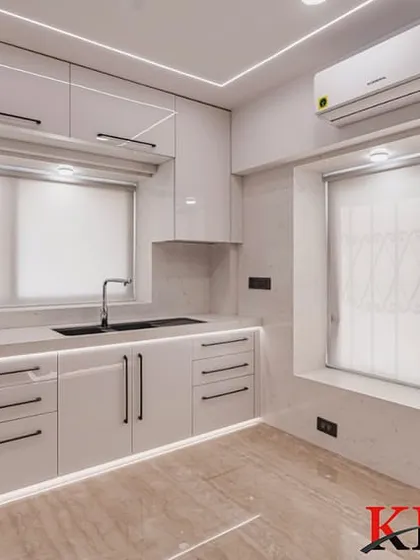 A shot of the sink area, featuring a modern black sink and faucet that contrasts beautifully with the white countertops.