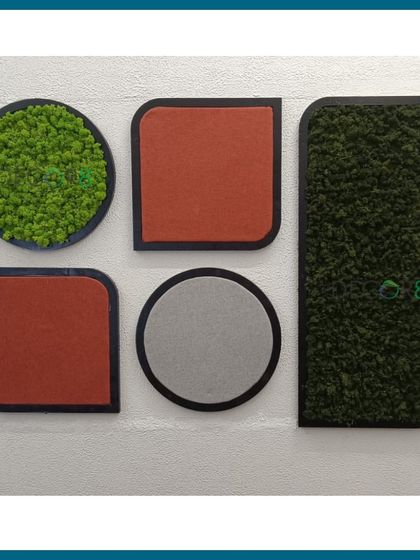 Moss can be combined with other materials like acoustic felt panels to create functional art. This installation uses circular and rectangular shapes with different textures and colors for a playful yet sophisticated wall feature that also helps with sound dampening.