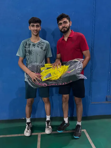 Hard work gets rewarded. Here I am with one of my champions, gifting him a new kit to celebrate his victory. I believe in recognizing the dedication my players show, motivating them to aim even higher.