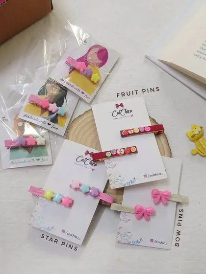 A collection of our smaller, non-crochet hair pins. This includes star pins, fruit pins, and simple bow pins, perfect for the holidays.