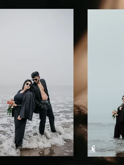 A moody and stylish pre-wedding shot of a couple in black suits, standing confidently in the ocean waves.