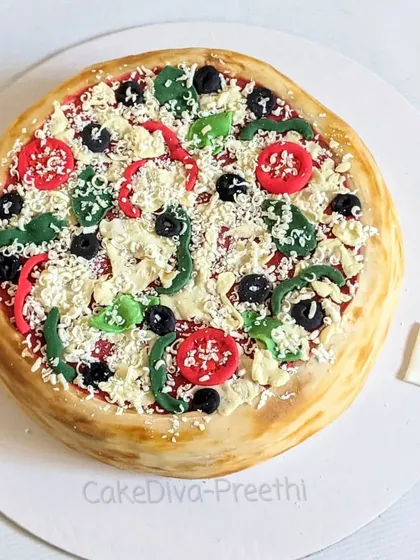 This hyper-realistic pizza cake is one of my favorites to make because it always gets a "wow" reaction. Every topping, from the olives and peppers to the grated cheese, is handcrafted from fondant and white chocolate to look just like the real thing.