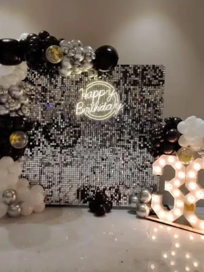 For a chic and modern celebration, I create stunning photo backdrops like this one. A silver shimmer wall paired with a custom neon sign, marquee age numbers, and an elegant black, white, and silver balloon garland makes for an unforgettable 38th birthday party.