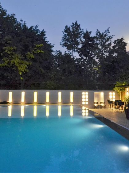 This 500-meter long swimming pool is a tranquil oasis designed for the ultimate retreat. The minimalist wall with slit lighting creates a serene, resort-like atmosphere at dusk.