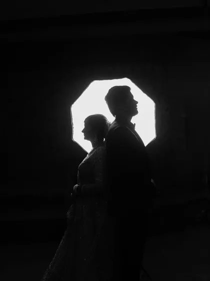 I love playing with light and shadow to create artistic and memorable shots. This silhouette portrait from a reception uses backlighting to create a powerful and romantic image that focuses entirely on the couple's profile and connection.