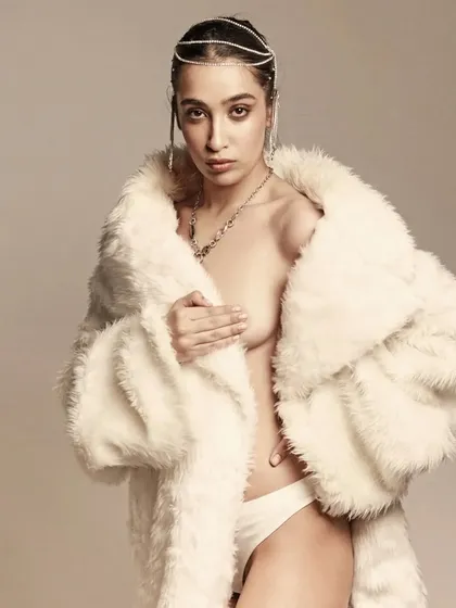 A more daring shot from the same series, where the styling and the soft, glowing makeup create a look of vulnerable, yet confident, elegance.