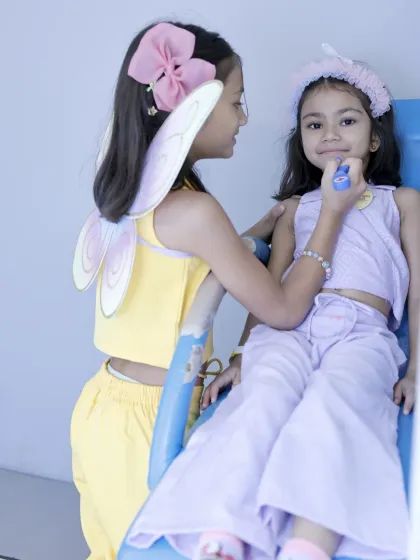 Pretend play is part of the party fun. Here, two friends enjoy a make-believe makeover session.