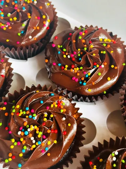 Sometimes, simple is best. Our classic chocolate cupcakes are a huge hit, topped with a rich chocolate buttercream swirl and a dash of colorful sprinkles for a fun, festive touch. They are perfect for any occasion or just to satisfy a sweet craving.