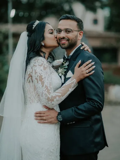 A sweet kiss filled with joy and affection after a Catholic wedding ceremony. These are the unscripted, heartfelt moments that truly define your wedding day.