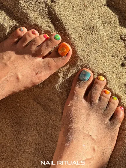 A closer look at our beach-ready toe art. This shot highlights the colorful and creative designs that make our summer pedicures so special.