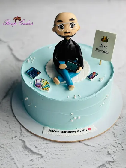 A custom cake for a partner, featuring a detailed fondant figurine that captures his likeness, complete with glasses and his favorite gadgets.