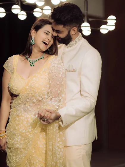 A moment of pure, unscripted laughter. The groom whispers something to his bride-to-be, and her resulting joy is beautifully captured, showcasing the genuine connection that makes for the best photographs.