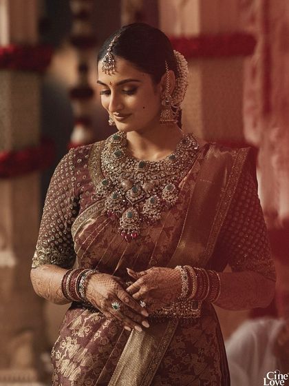 A portrait of bride Sree in her traditional South Indian wedding saree by Shravan Kummar. The rich maroon and gold tones are complemented by elaborate temple jewellery.