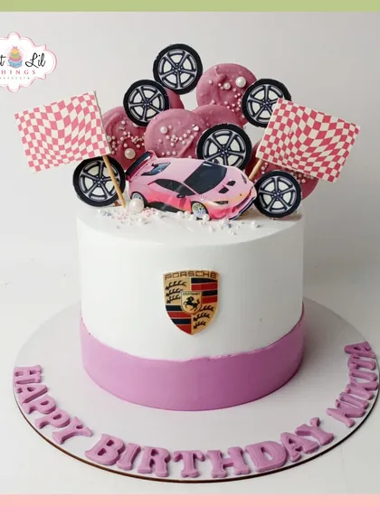 A pretty-in-pink Porsche-themed cake for Nimisha's birthday, combining a love for luxury cars with a feminine touch.