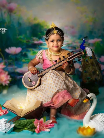 This little Saraswati, holding a mini veena, sits in a lotus and is surrounded by swans and a peacock, creating a truly divine scene.