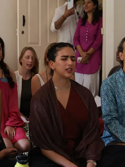 Faces of devotion during a kirtan. Each person is immersed in their own experience, yet we are all connected by the shared vibration of the mantra, creating a powerful collective energy.
