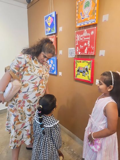 Visitors of all ages admiring the colorful and diverse artwork created by my students. The exhibition was a huge success.