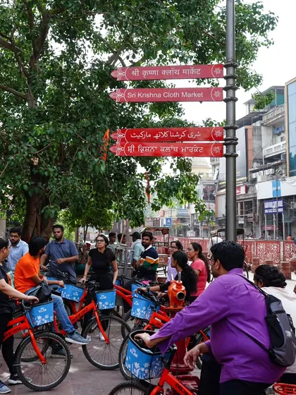 Our guide points out a detail on a sign for the Sri Krishna Cloth Market. We love sharing the history behind the famous markets of Chandni Chowk.