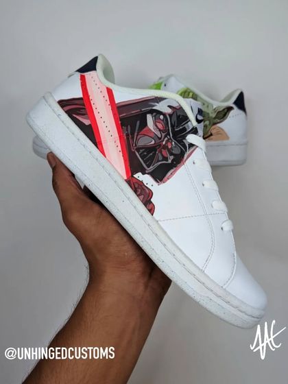 The Dark Side. A custom Nike Court sneaker featuring a portrait of Darth Vader and his iconic red lightsaber.
