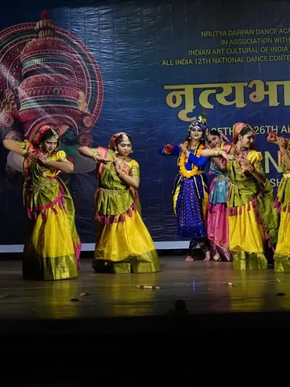 The gopis surround Krishna in this lively scene from our stage show. Group choreography teaches my students coordination, spatial awareness, and the joy of dancing together.