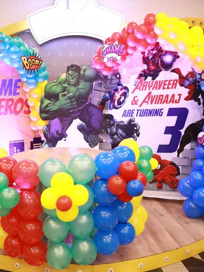 We bring any theme to life. This is a look at our superhero party setup, complete with a custom backdrop, balloon arches, and a themed cake table, ready for the birthday heroes.