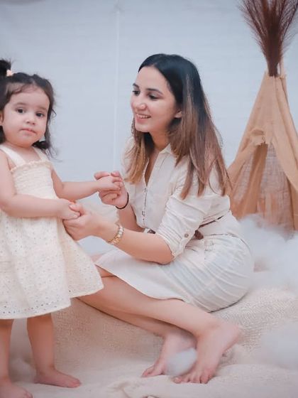 A mother and daughter holding hands in a dreamy, boho-themed setup. We can create beautiful, styled sessions for your family portraits.