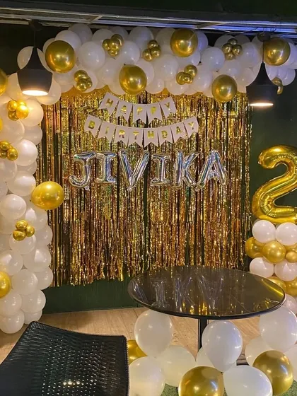 This shot shows the complete gold and white backdrop, ready for cake cutting and photos.