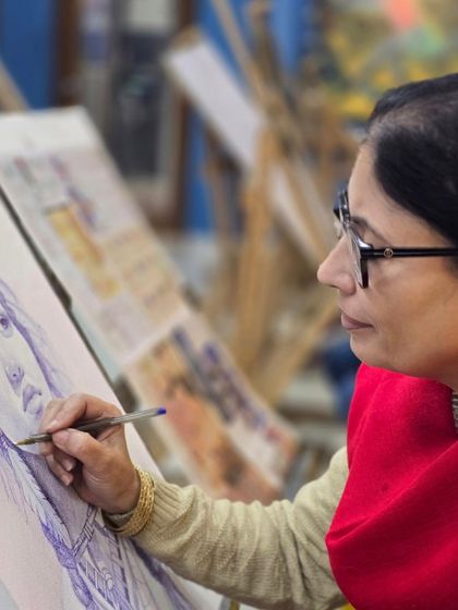 A profile shot of a student focused on her portrait drawing, demonstrating the careful precision taught in our classes.
