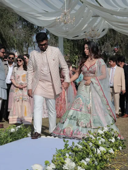 A closer view of the couple's entrance, hand in hand, ready to celebrate with their loved ones.