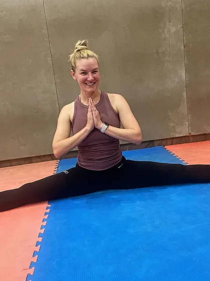 After a tough workout, we focus on flexibility. Here, actress Courtney Chen holds a full split, showcasing the incredible mobility we work to develop.