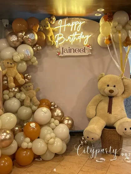 For this first birthday, we created a full teddy bear theme with a custom neon sign, a large teddy bear prop, and a balloon arch in earthy tones of cream, brown, and rose gold.