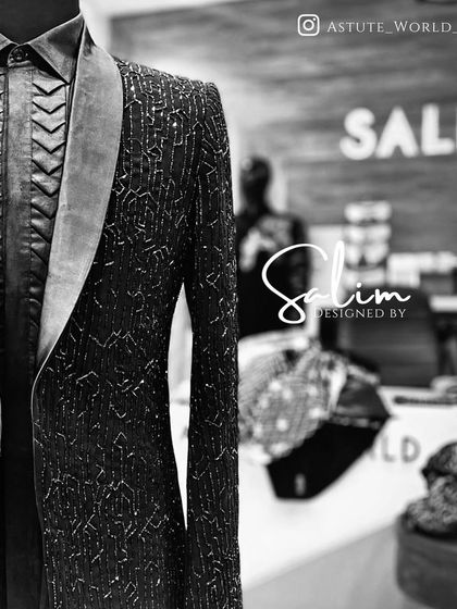 A close-up shot of a black embellished jacket on a mannequin. The detail shows a textured shirt and a satin lapel, highlighting the different materials I use.