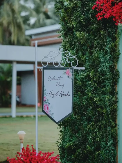 A charming welcome sign for a Roce ceremony. The elegant floral design and classic wrought-iron stand create a sweet and inviting entrance for guests.