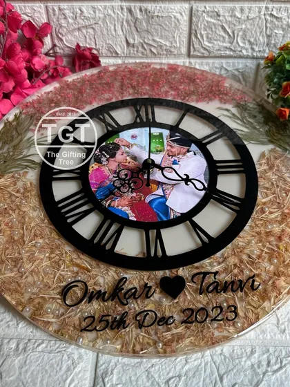 An angled view that captures the glossy finish and the texture of the different preserved flowers used in this custom clock.