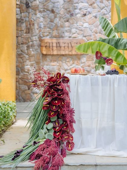 The stunning floral runner of the Orchard Table cascades down to the stone pathway. This dramatic touch makes for an unforgettable visual statement.