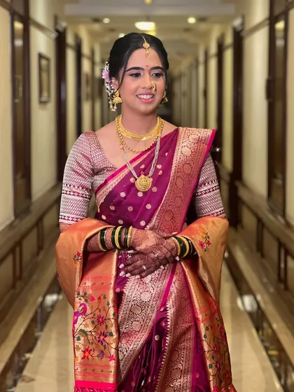 A full-length shot in a classic hallway, showcasing the beautiful drape of the saree.