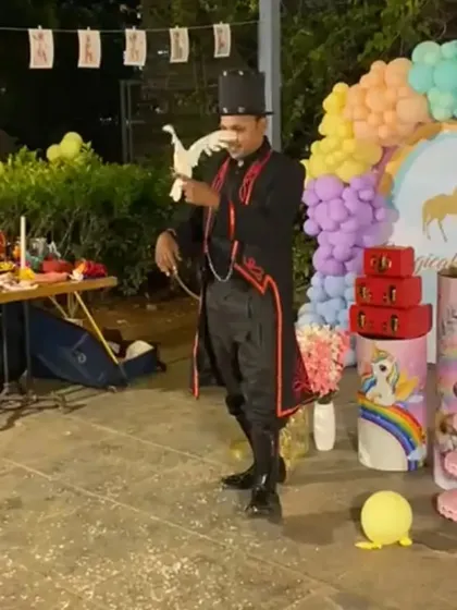 Performing the appearing dove trick at an outdoor unicorn themed birthday party. The natural light and open space add a unique charm to the magic.