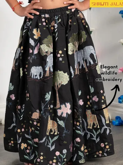 A detailed shot of the elegant wildlife embroidery on the skirt of my jungle-themed lehenga. I love adding these unique, playful touches.
